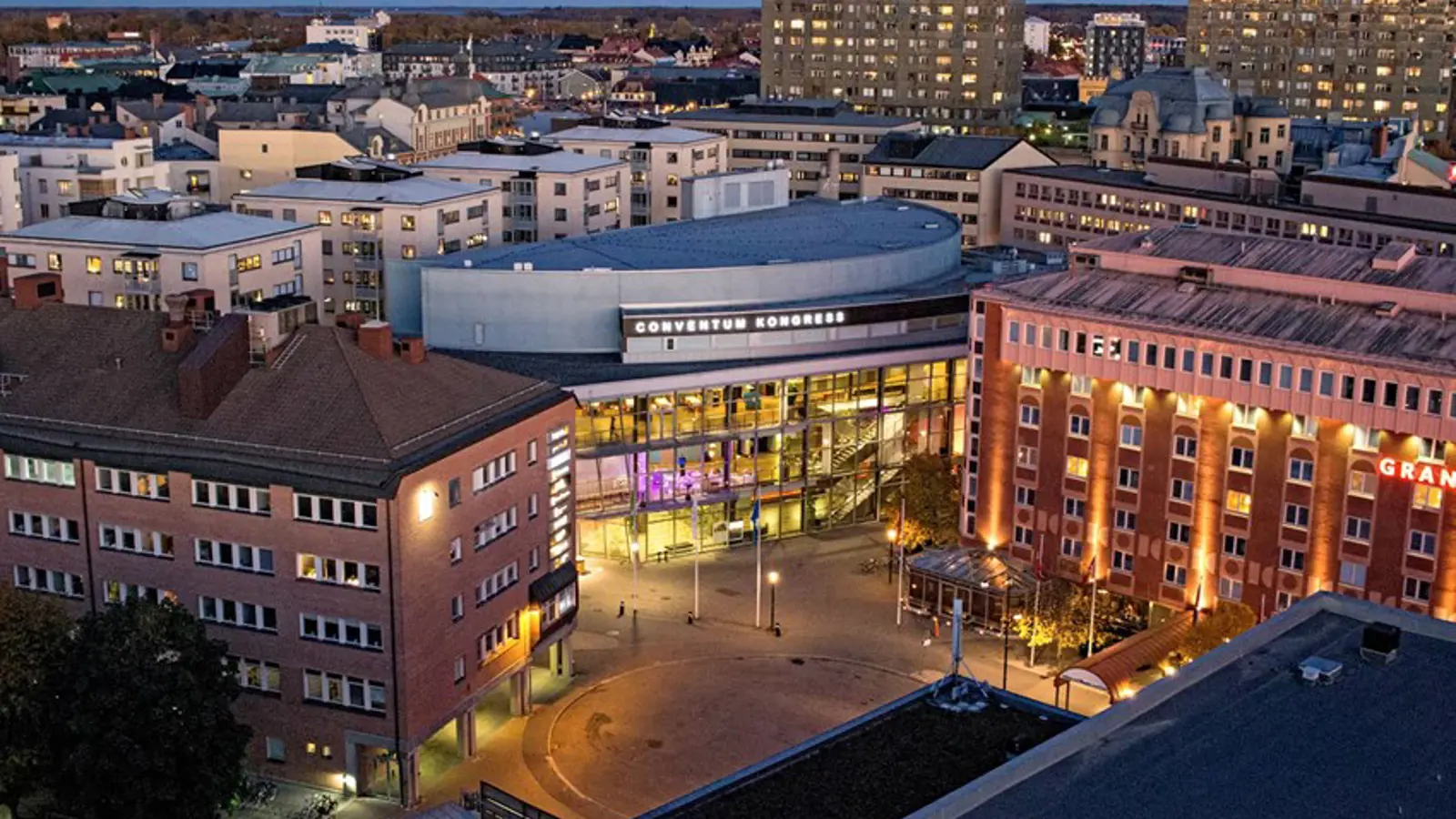 Våningshus och större byggnader fotade ovanifrån i skymning
